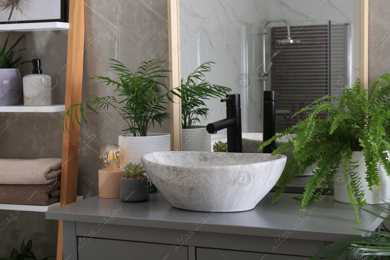 Photo of Modern bathroom interior with stylish vessel sink and beautiful green houseplants