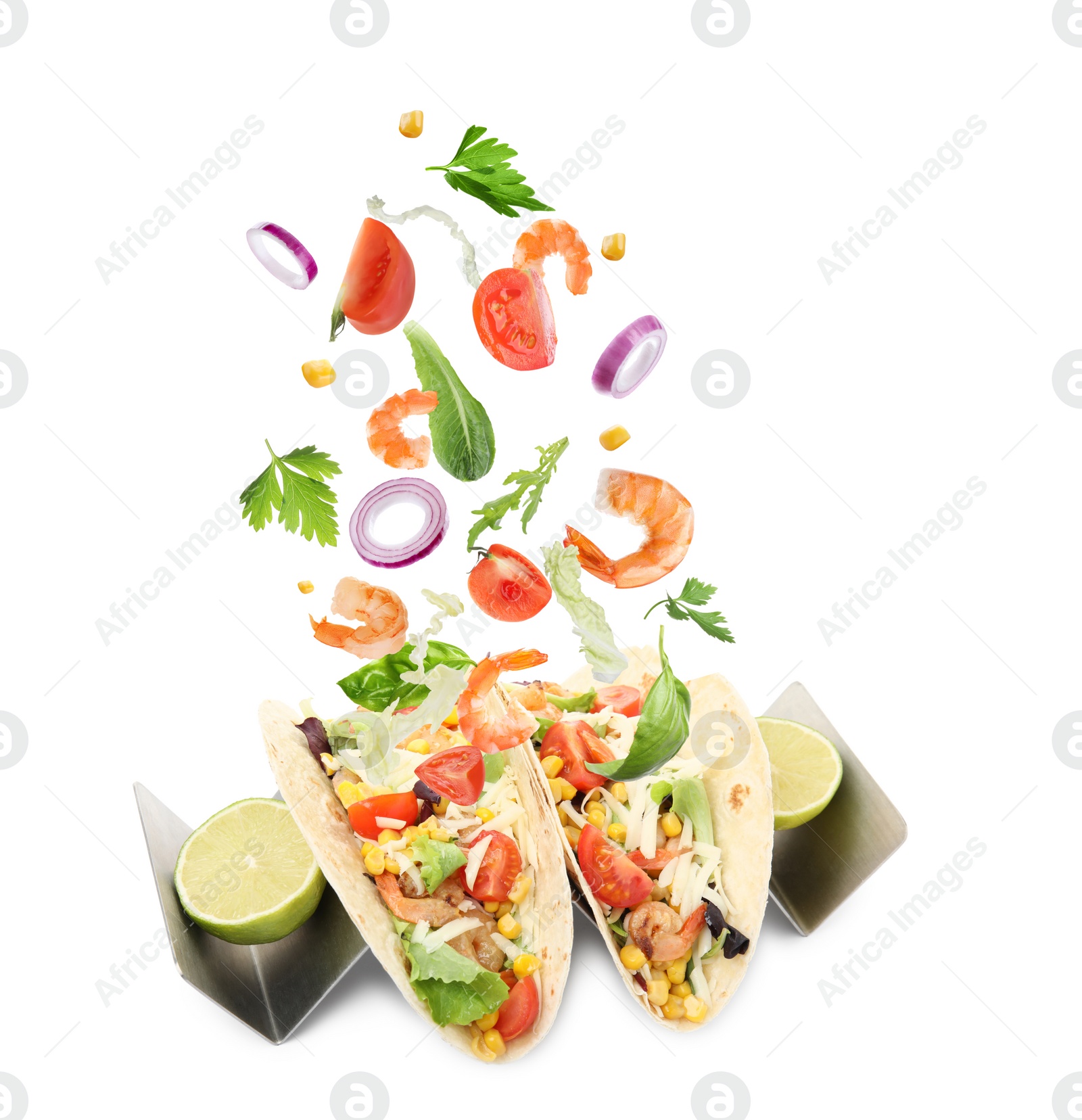 Image of Delicious tacos. Ingredients falling into tortillas on white background