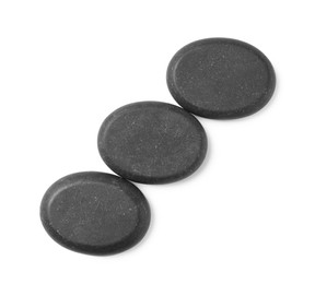 Group of black stones on white background, top view