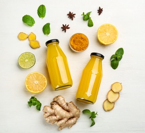 Photo of Flat lay composition with immunity boosting drink and ingredients on white wooden table