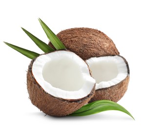 Image of Tasty ripe coconuts and green leaves on white background