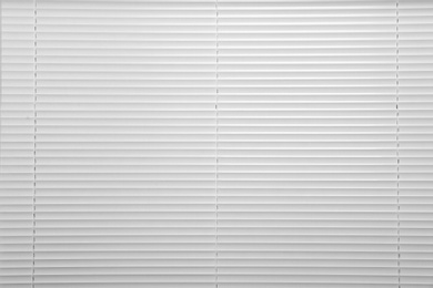 Photo of Window with closed white horizontal blinds as background