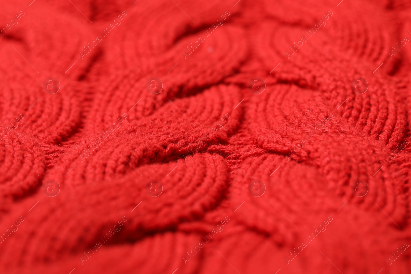 Photo of Texture of soft red knitted fabric as background, closeup