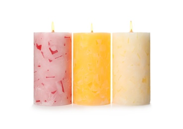 Alight color wax candles on white background