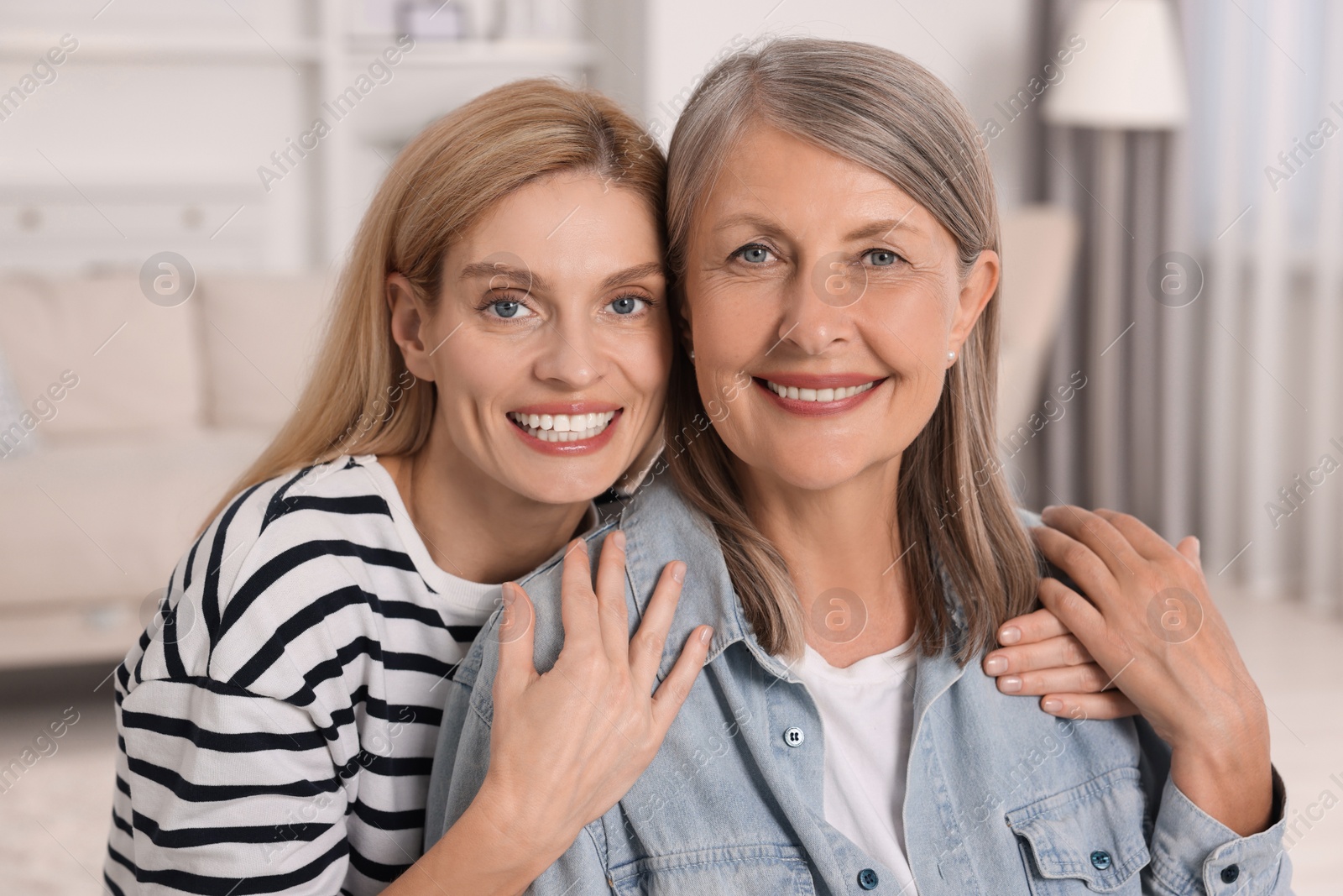 Photo of Happy mature mother and her daughter at home