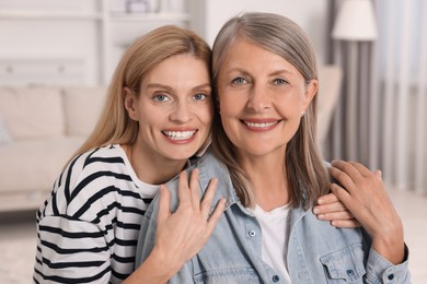 Happy mature mother and her daughter at home