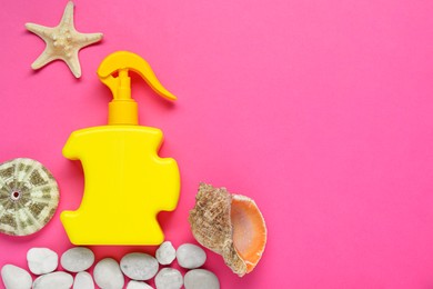 Photo of Bottle of suntan cream, pebbles and seashells on pink background, flat lay. Space for text