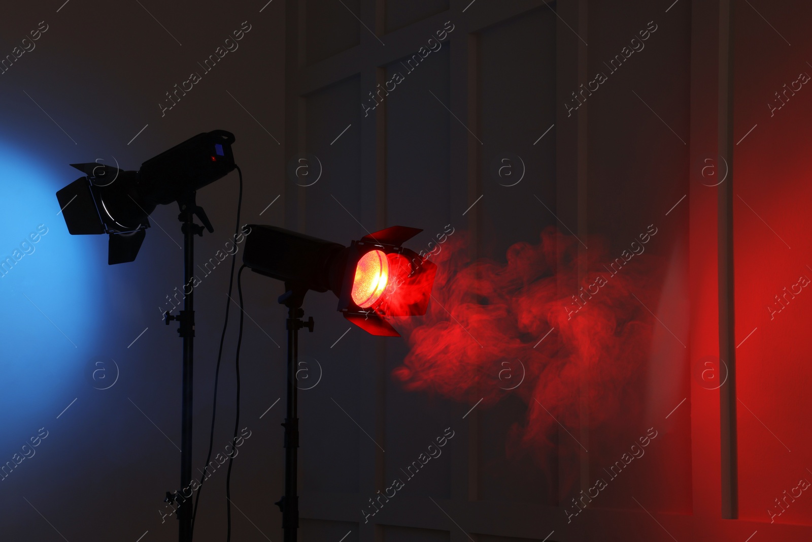 Photo of Bright spotlights near wall in dark room, space for text