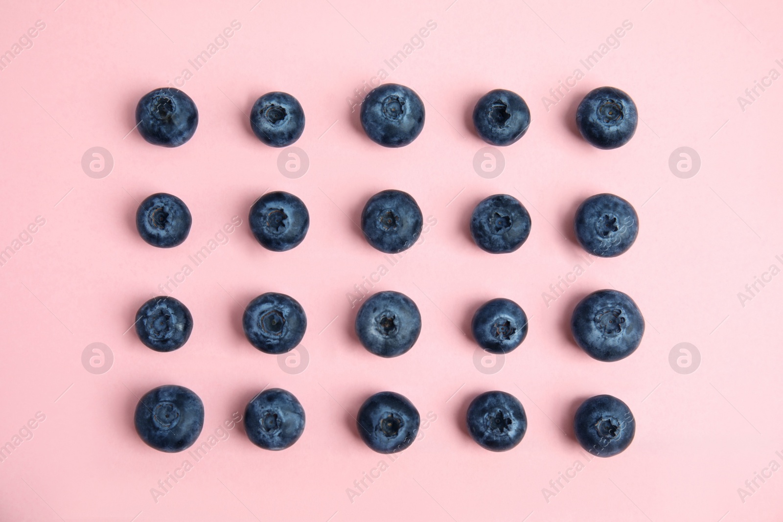 Photo of Fresh ripe blueberries on pink background, flat lay