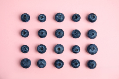 Photo of Fresh ripe blueberries on pink background, flat lay