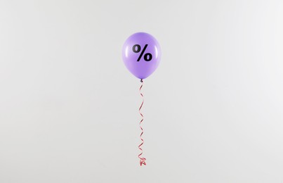 Discount offer. Violet balloon with percent sign on white background