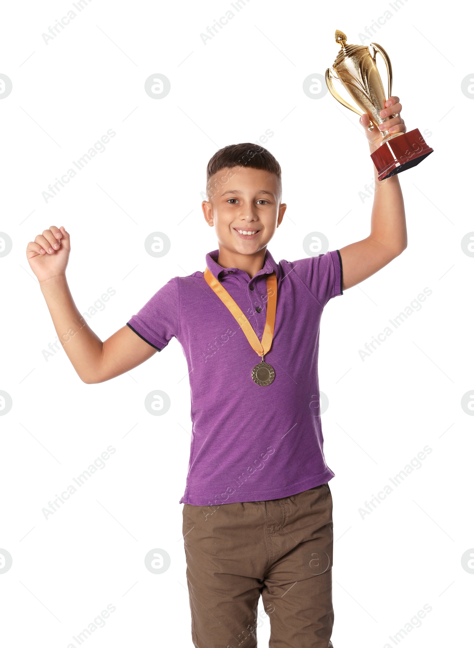 Photo of Happy boy with golden winning cup and medal on white background