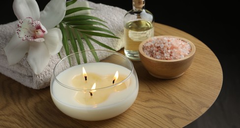 Composition with different spa products and orchid flower on wooden table