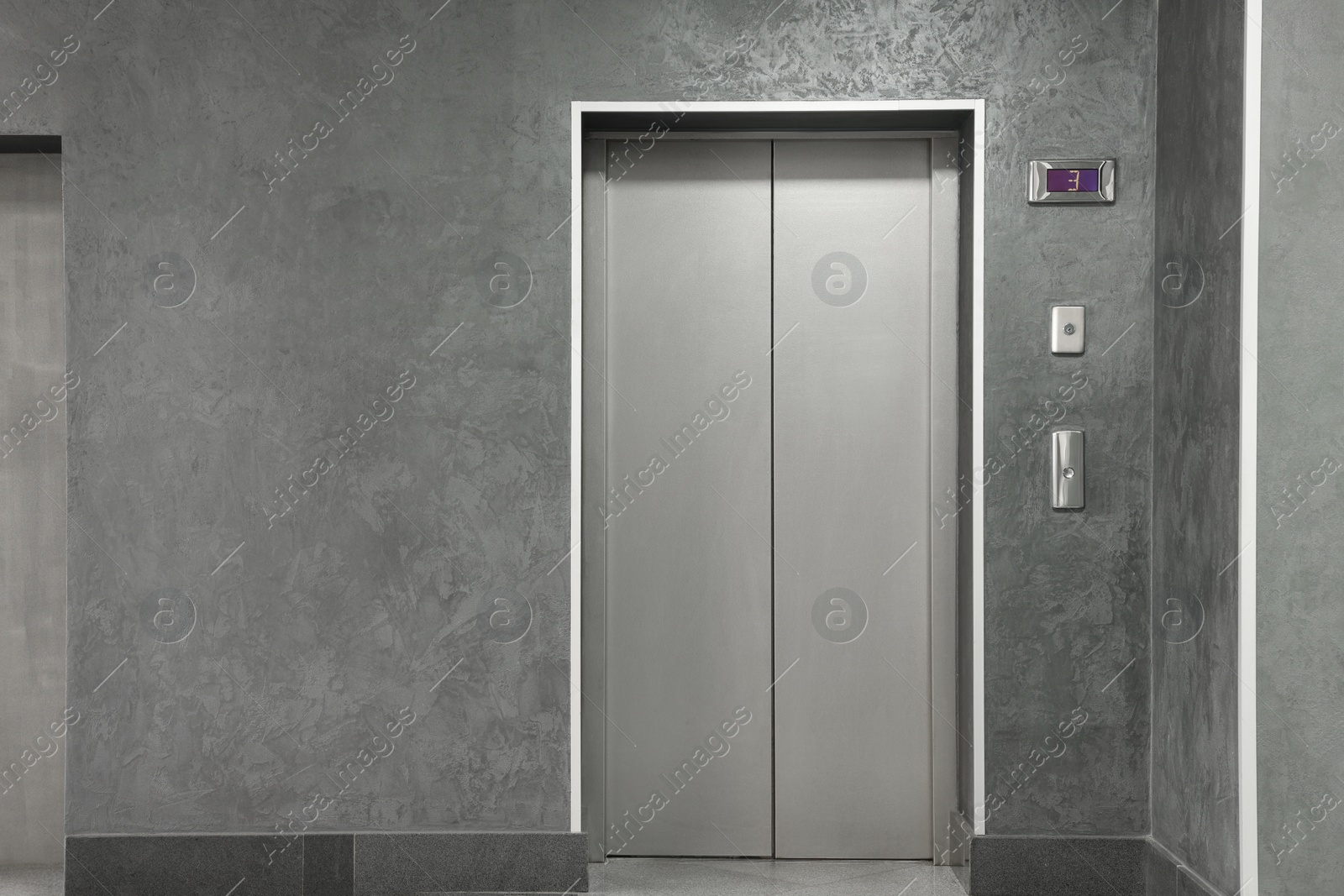 Photo of Closed stylish elevator door in clean hall