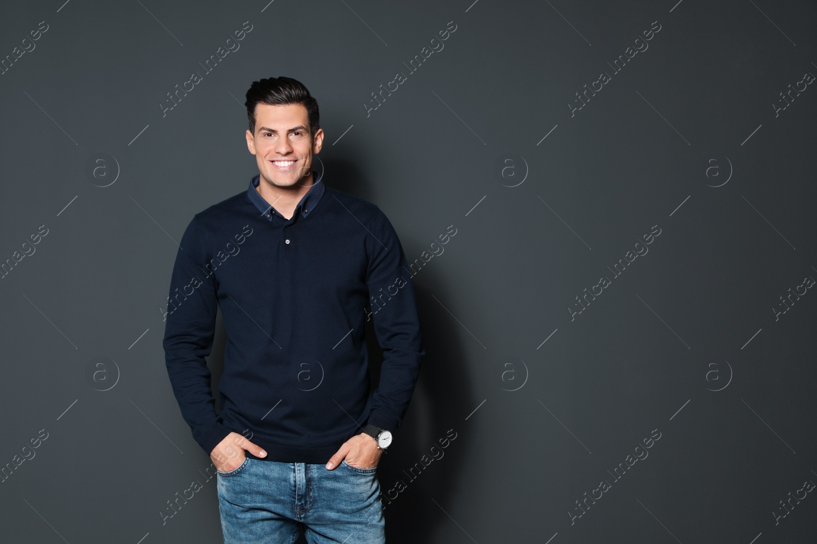 Photo of Portrait of handsome man smiling on grey background. Space for text