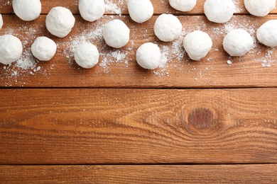 Photo of Snowballs on wooden background, flat lay. Space for text
