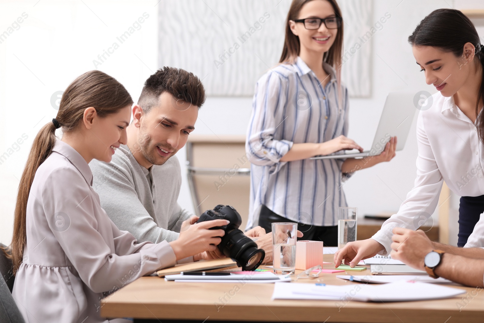 Photo of Team of professional journalists working in office