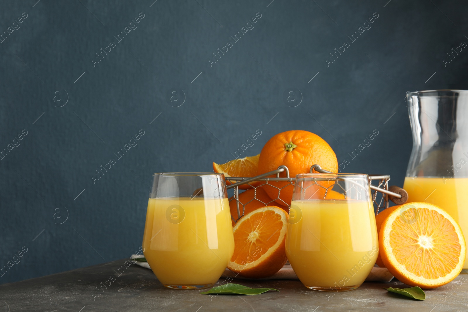 Photo of Composition with orange juice and fresh fruit on table, space for text