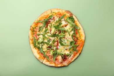 Photo of Delicious vegetarian pizza on green table, top view