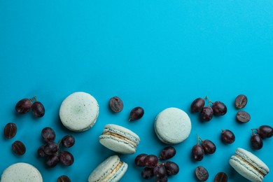 Photo of Flat lay composition with macarons and grapes on light blue background. Space for text