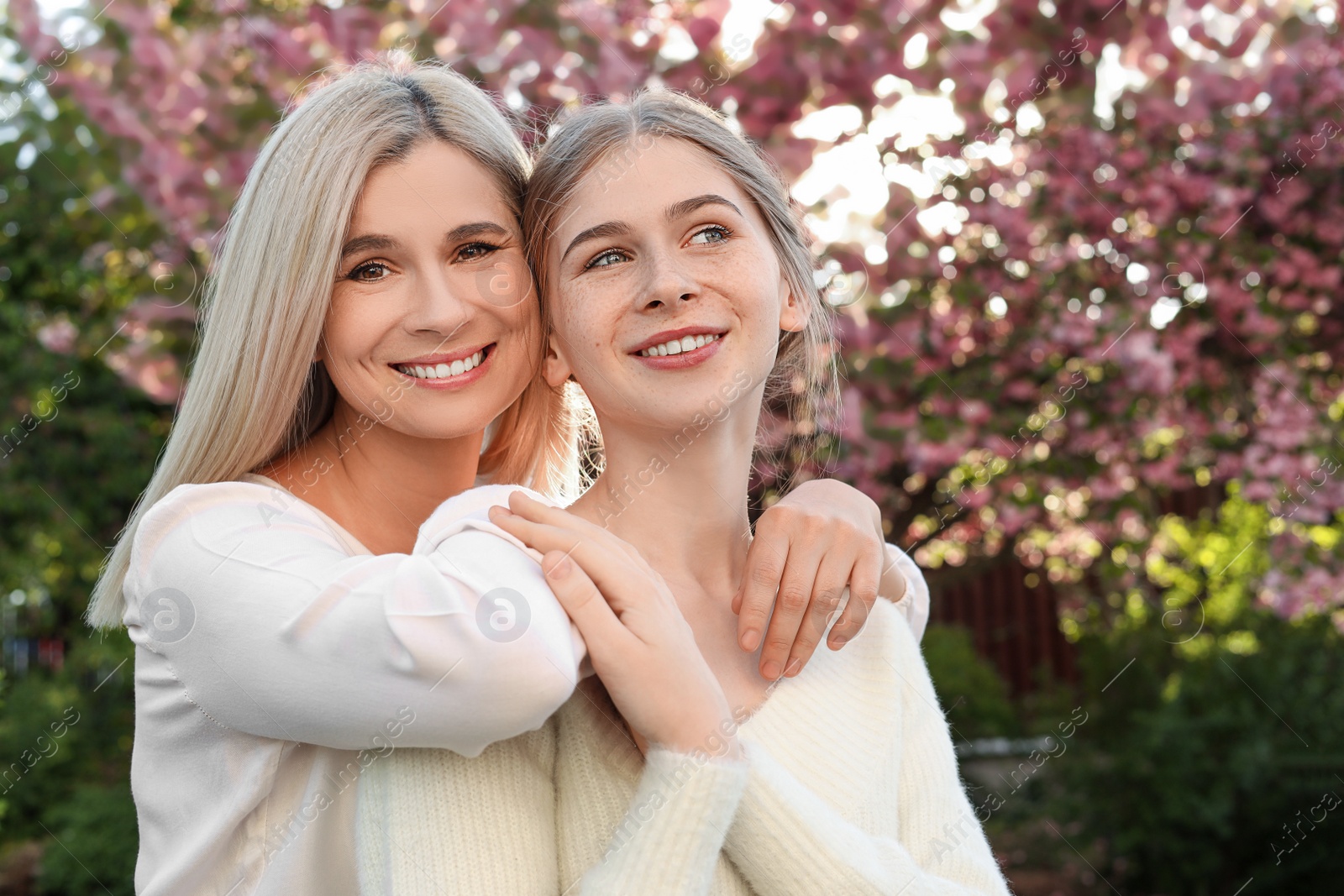 Photo of Happy mother with her daughter spending time together in park on sunny day