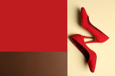 Photo of Stylish high heel shoes on color background, top view. Space for text