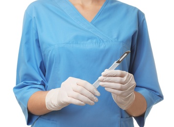 Photo of Female doctor holding scalpel on white background, closeup. Medical object