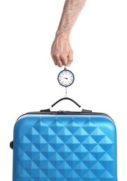 Man weighing stylish suitcase against white background, closeup