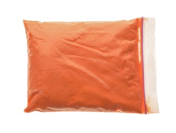 Orange powder in plastic bag isolated on white, top view. Holi festival celebration