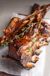 Photo of Delicious roasted ribs served on table, closeup