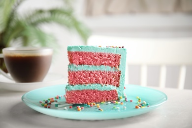 Slice of fresh delicious birthday cake on table indoors