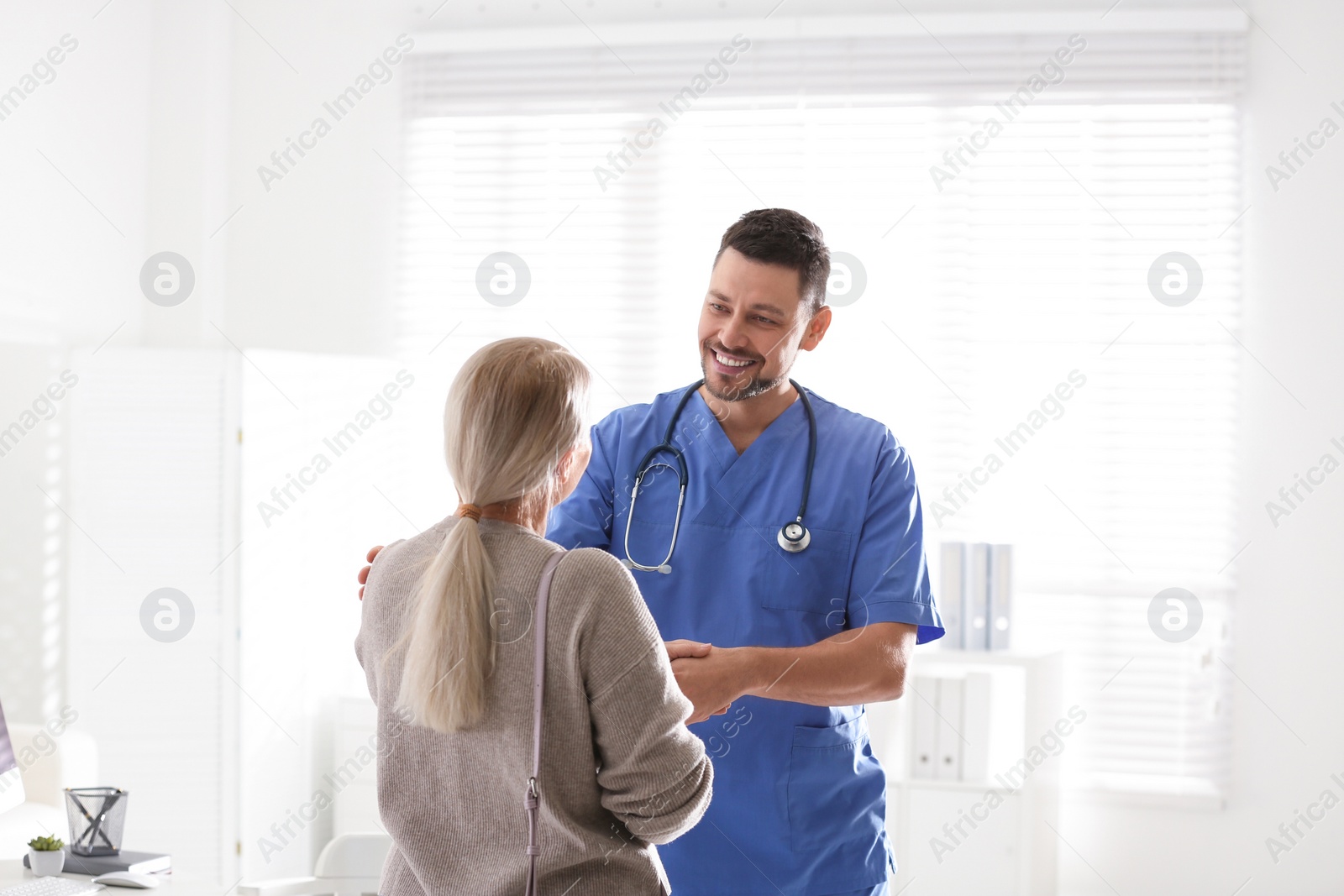 Photo of Doctor consulting patient in his office at hospital