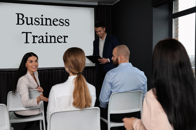 Image of Professional business trainer and his students in conference room with projection screen