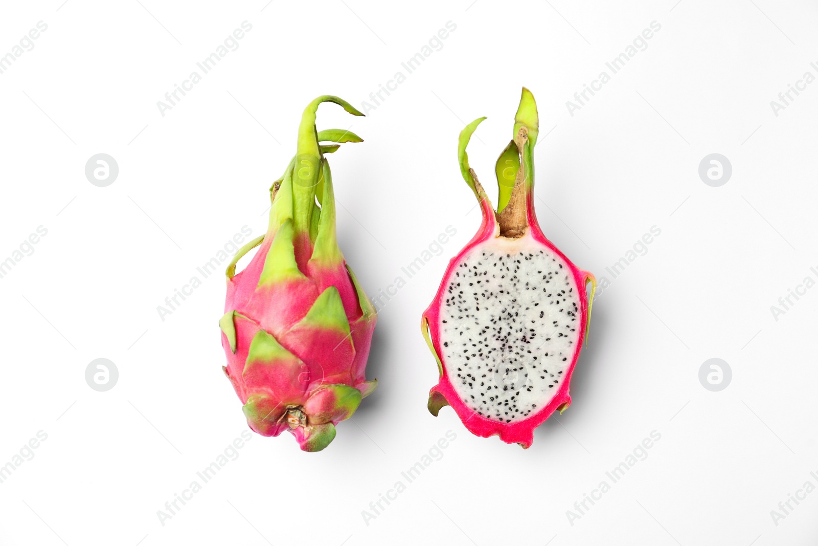 Photo of Delicious cut and whole dragon fruits (pitahaya) on white background, top view