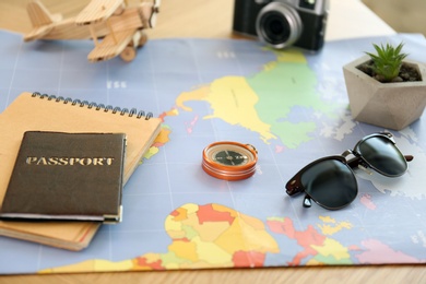 Photo of Composition with world map and different items on table. Trip planning