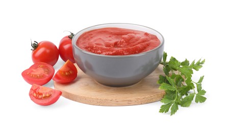 Photo of Organic ketchup in bowl, fresh tomatoes and parsley isolated on white. Tomato sauce