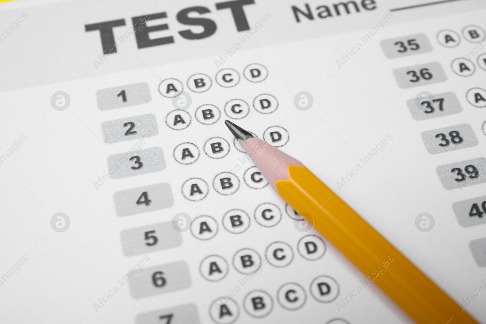 Photo of Pencil on answer sheet, closeup. Student passing exam