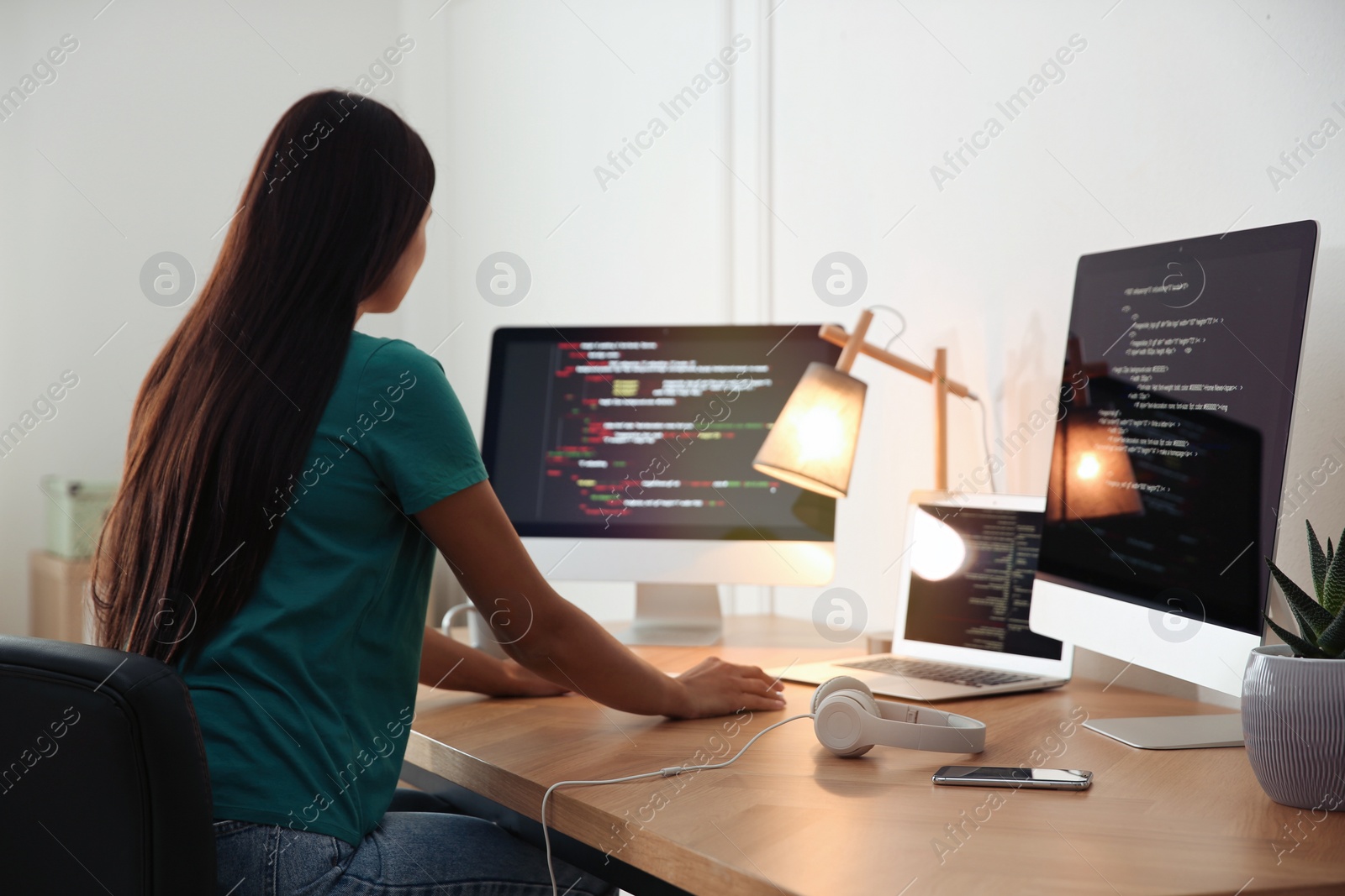 Photo of Programmer working at desk in modern office