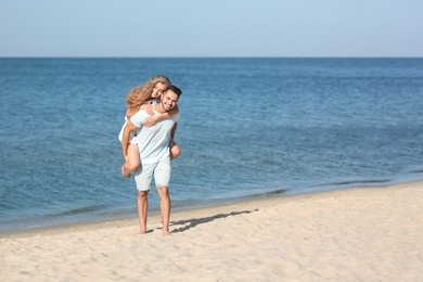 Photo of Happy young couple at beach on sunny day