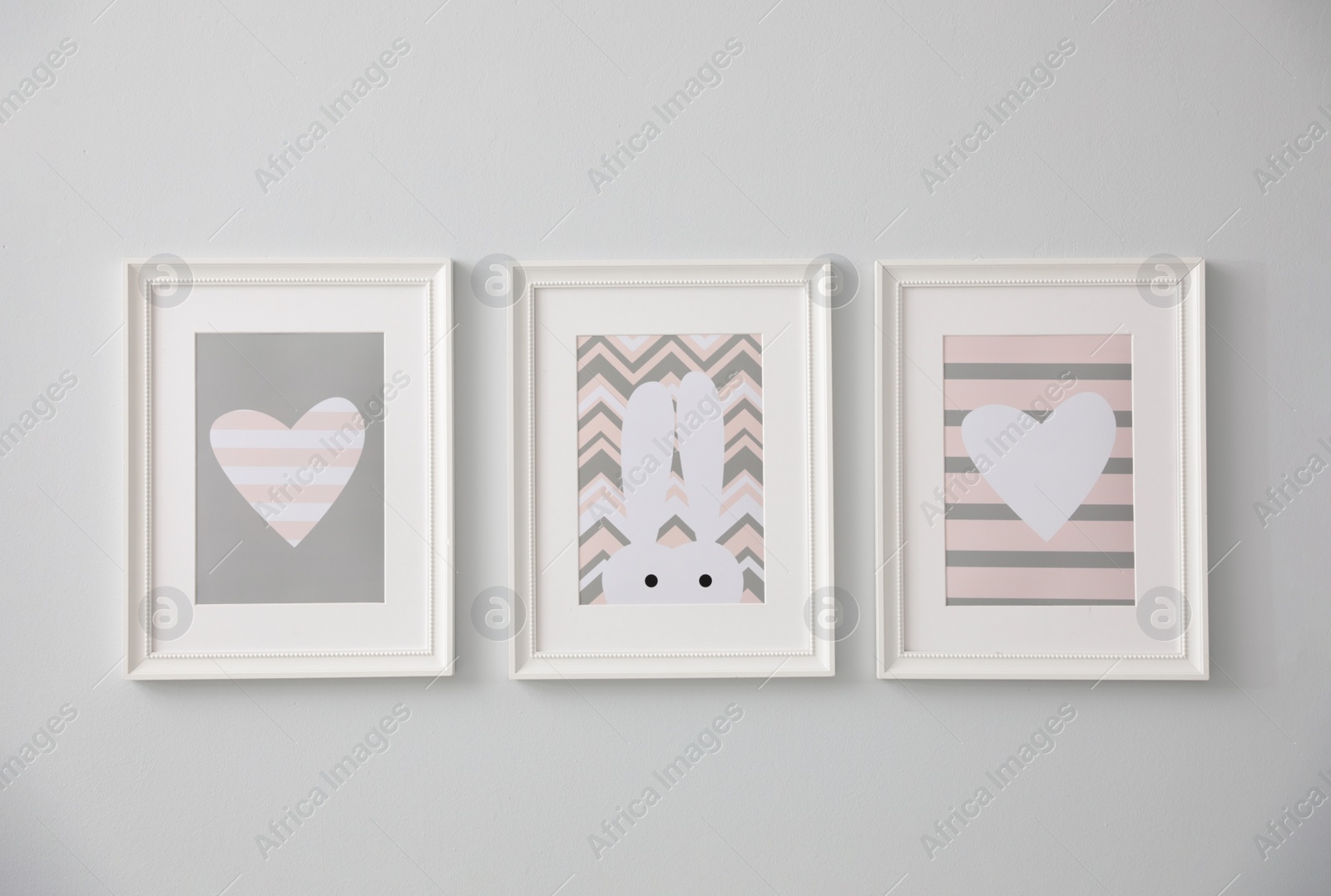 Photo of Different cute pictures on grey wall. Baby room interior