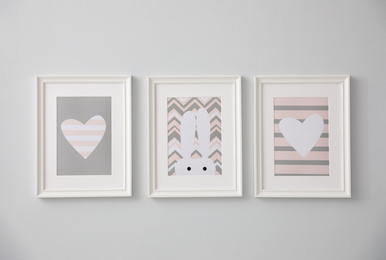 Photo of Different cute pictures on grey wall. Baby room interior