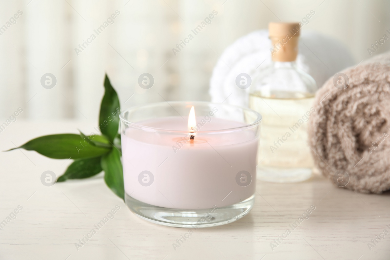 Photo of Spa composition with burning candle on table