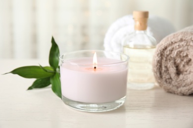 Photo of Spa composition with burning candle on table