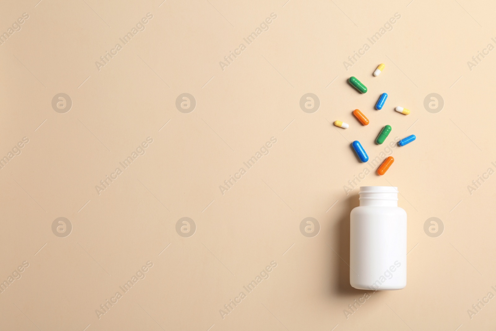 Photo of Flat lay composition with bottle, pills and space for text on color background