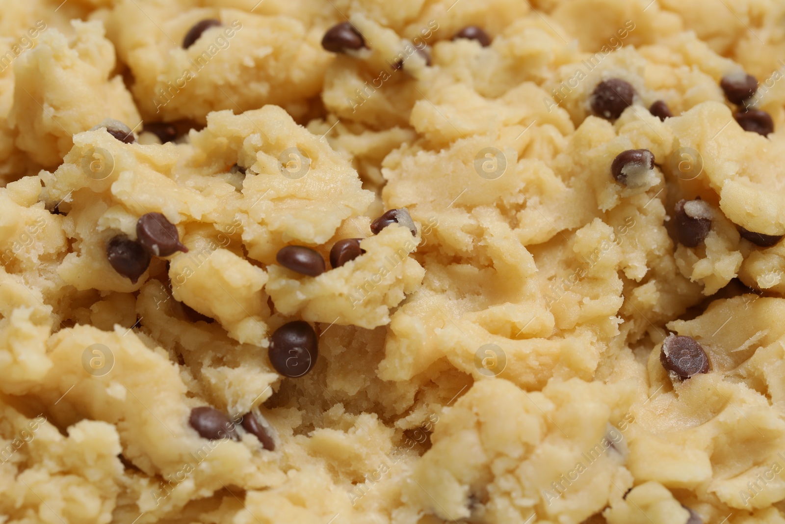 Photo of Raw dough for chocolate chip cookies as background, closeup