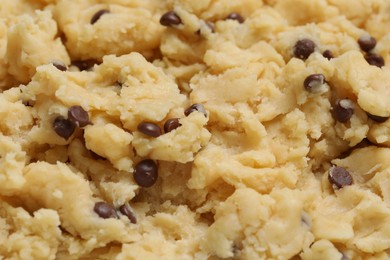 Raw dough for chocolate chip cookies as background, closeup