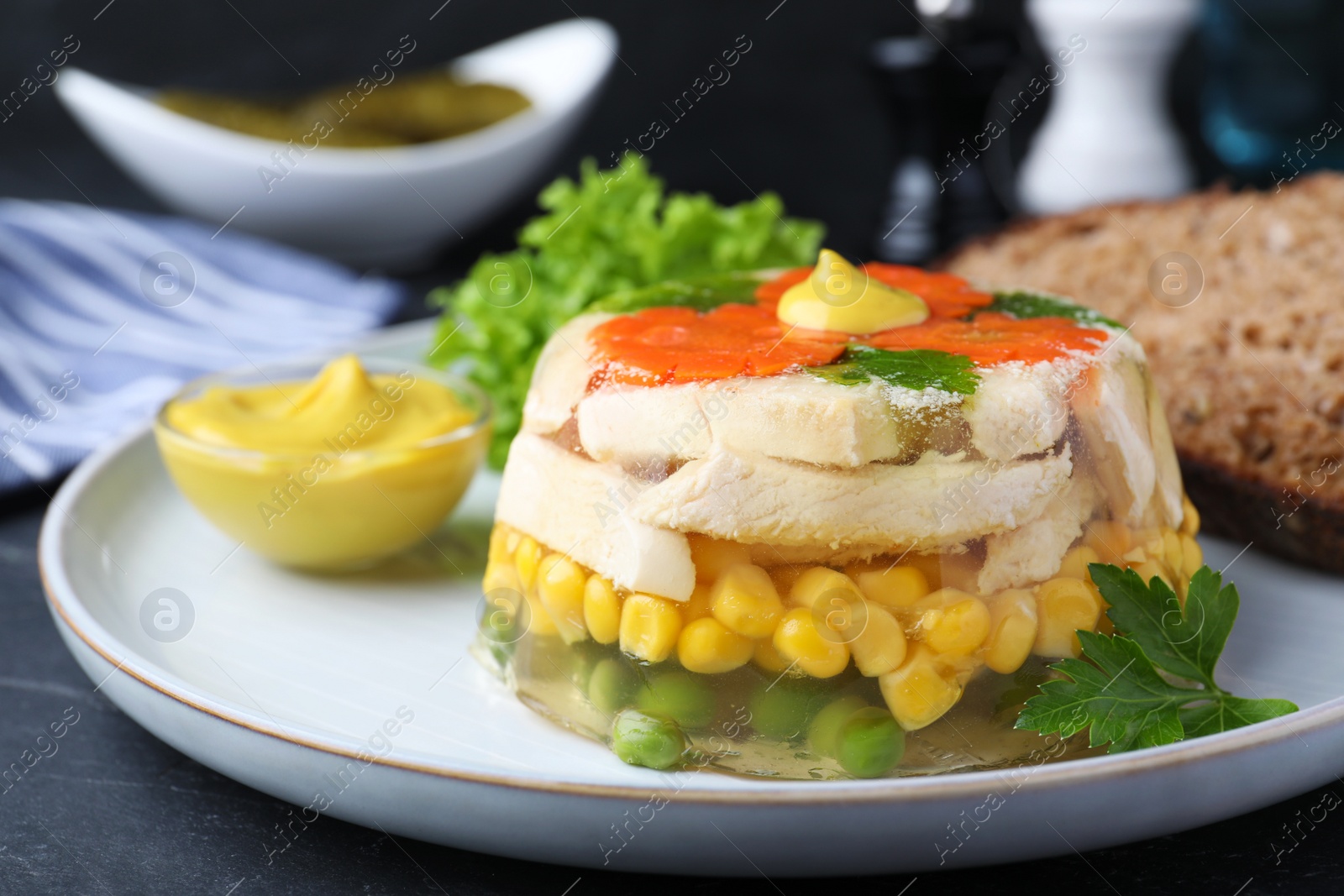 Photo of Delicious chicken aspic with vegetables on plate, closeup