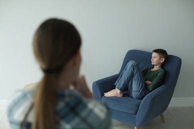 Photo of Sad boy and his worried mother at home