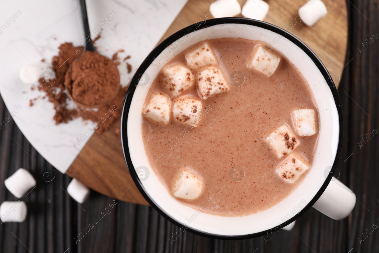 Photo of Cup of aromatic hot chocolate with marshmallows and cocoa powder served on table, top view