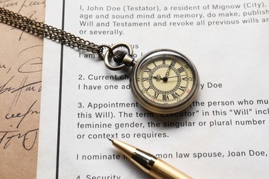 Photo of Last Will and Testament with pocket watch and pen, closeup